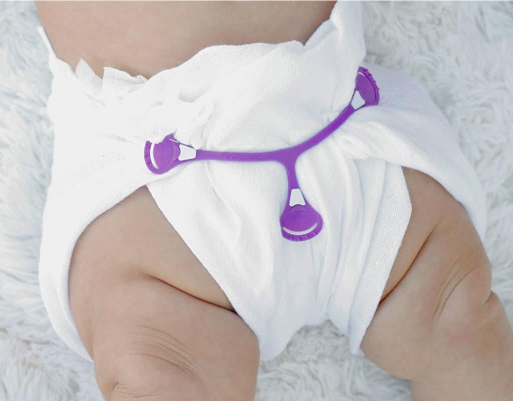 Snappi being used to fasten a cloth diaper.